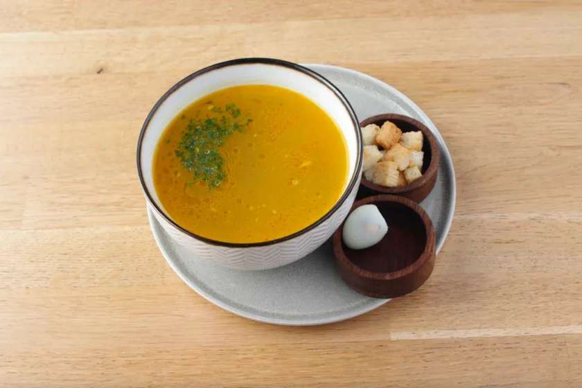 Chicken broth with homemade noodles and quail eggs