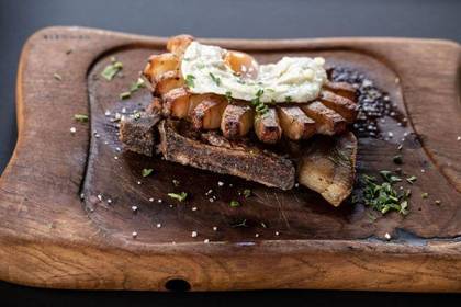 Pork Neck Served with Fried Bacon and Sunny Side Up Eggs