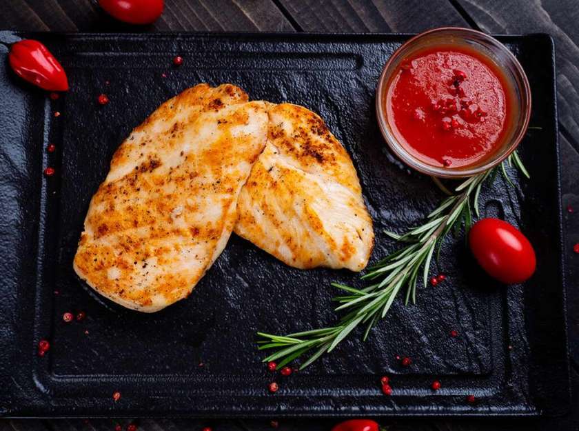 Grilled Chicken Breast, on a Wooden Charcoal Grill