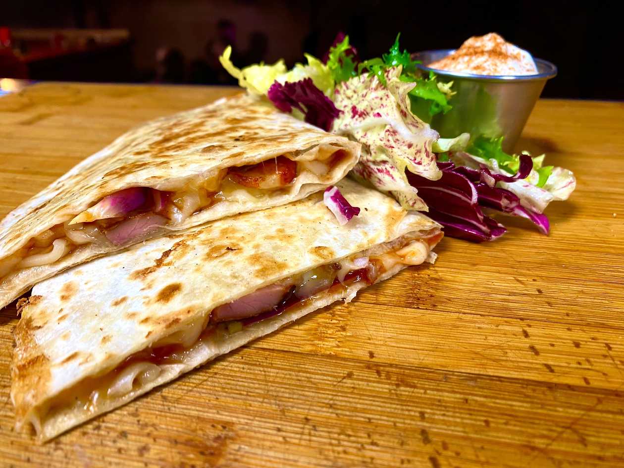 Quesadilla With Roasted Bacon, Cheddar Cheese, BBQ Sauce, Jalapeño Peppers, Red Onion, Sour Cream