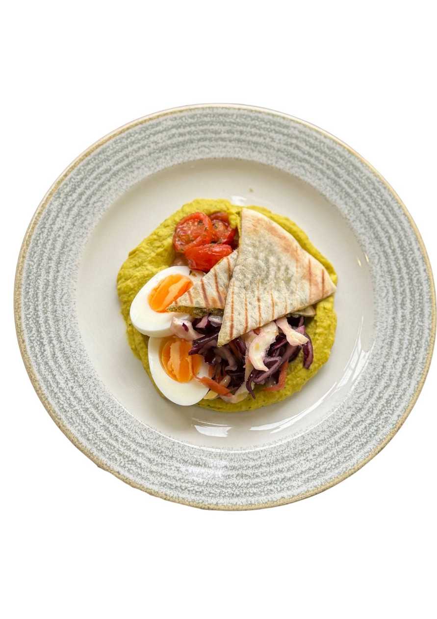 Hummus with egg, herb flatbread, and coleslaw salad.