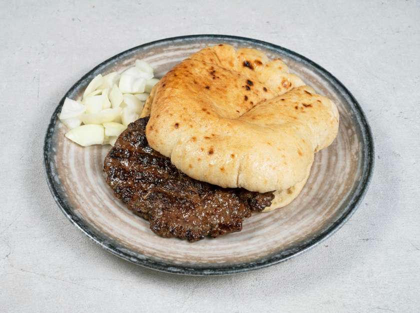 Meat patty  in a flatbread with onions