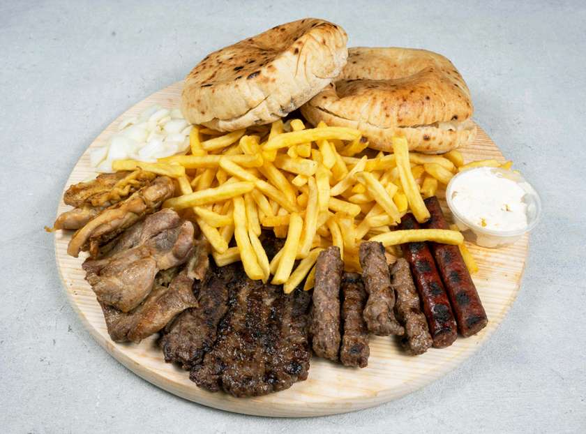 Plate for two people: 4 cevaps, 1 meat patty, two boneless drumsticks, two pieces of sudjuk, 1 piece of pork neck, two buns, fries, onions and kajmak