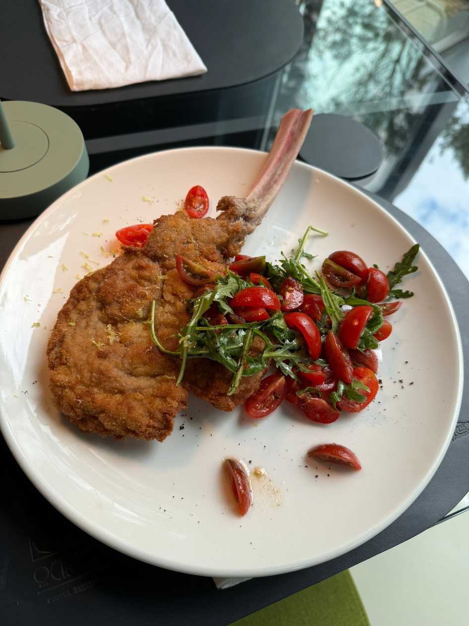 Chop Schnitzel Veal Served with Cherry Tomatoes and Arugula