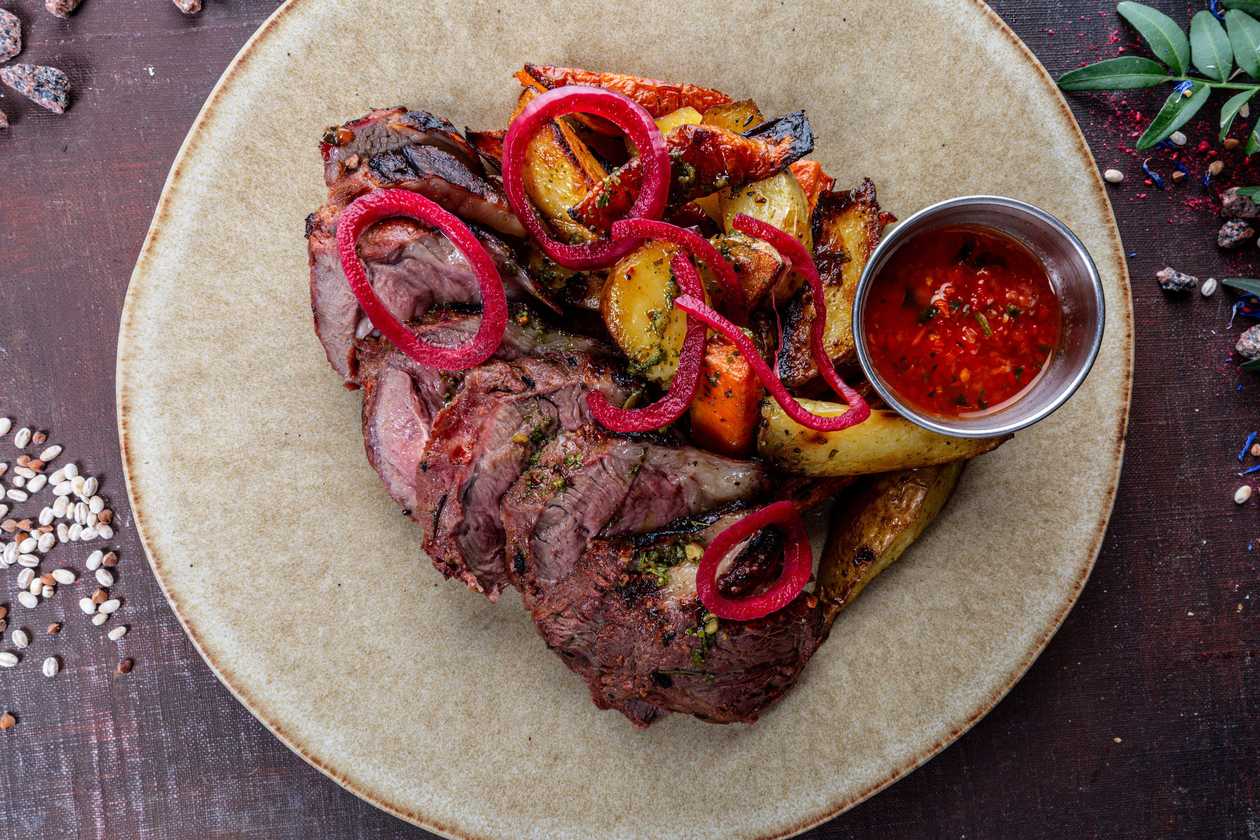 Lamb steak with baked vegetables, adjika