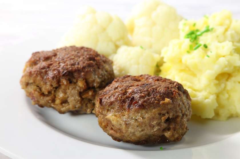 Breaded patty with spinach and side dish
