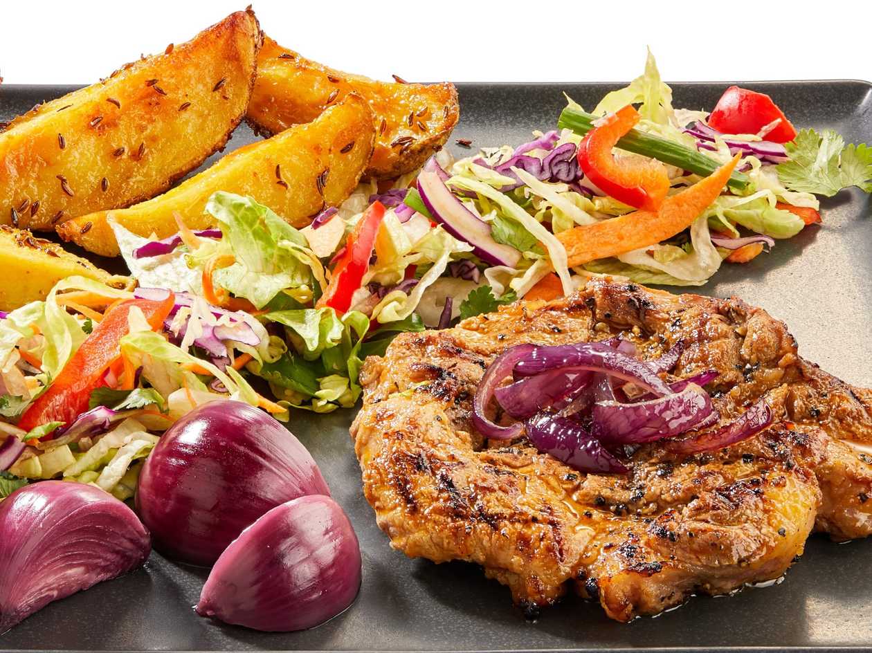 Pork neck steak with caramelized onions