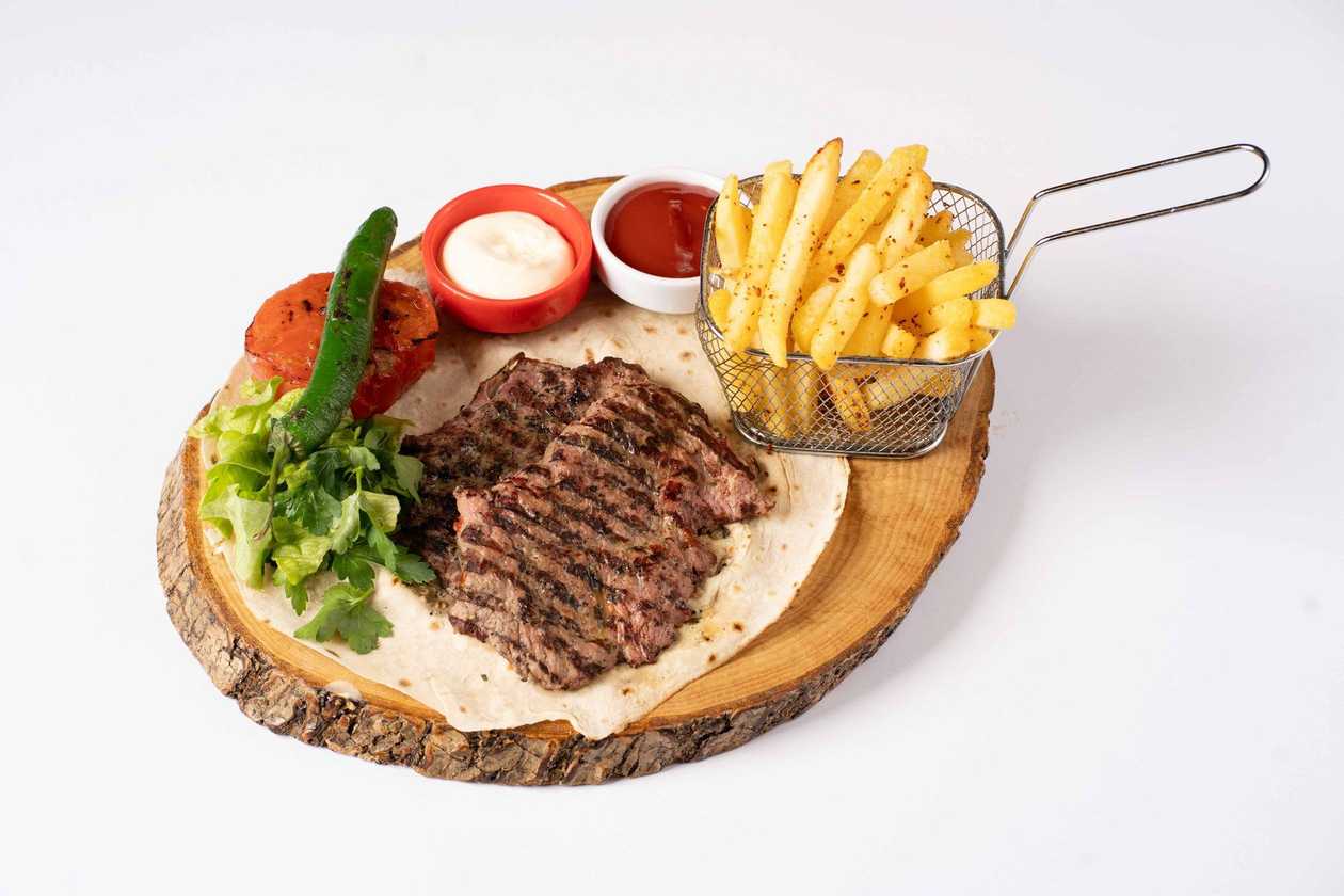 Grilled beef with fries.