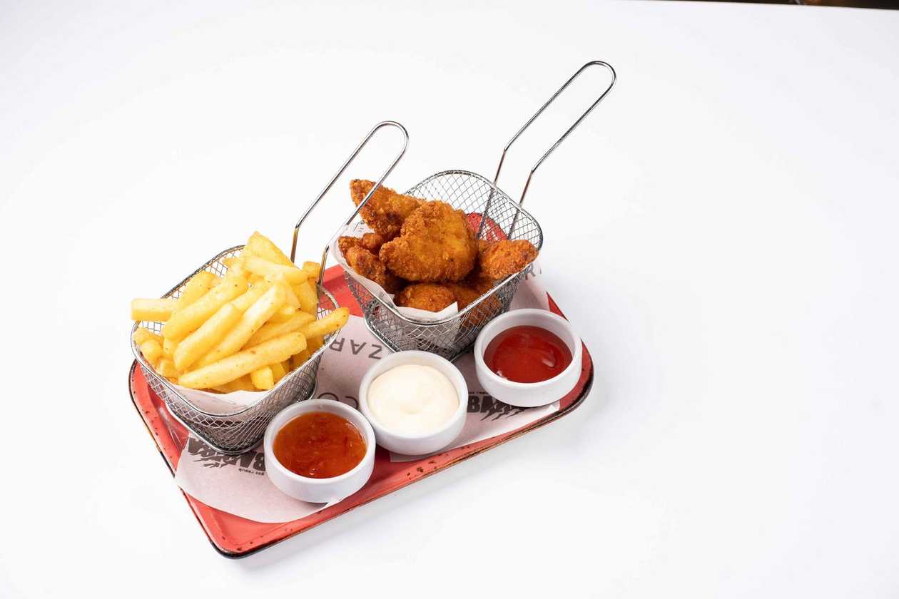 Chicken wings with fries.