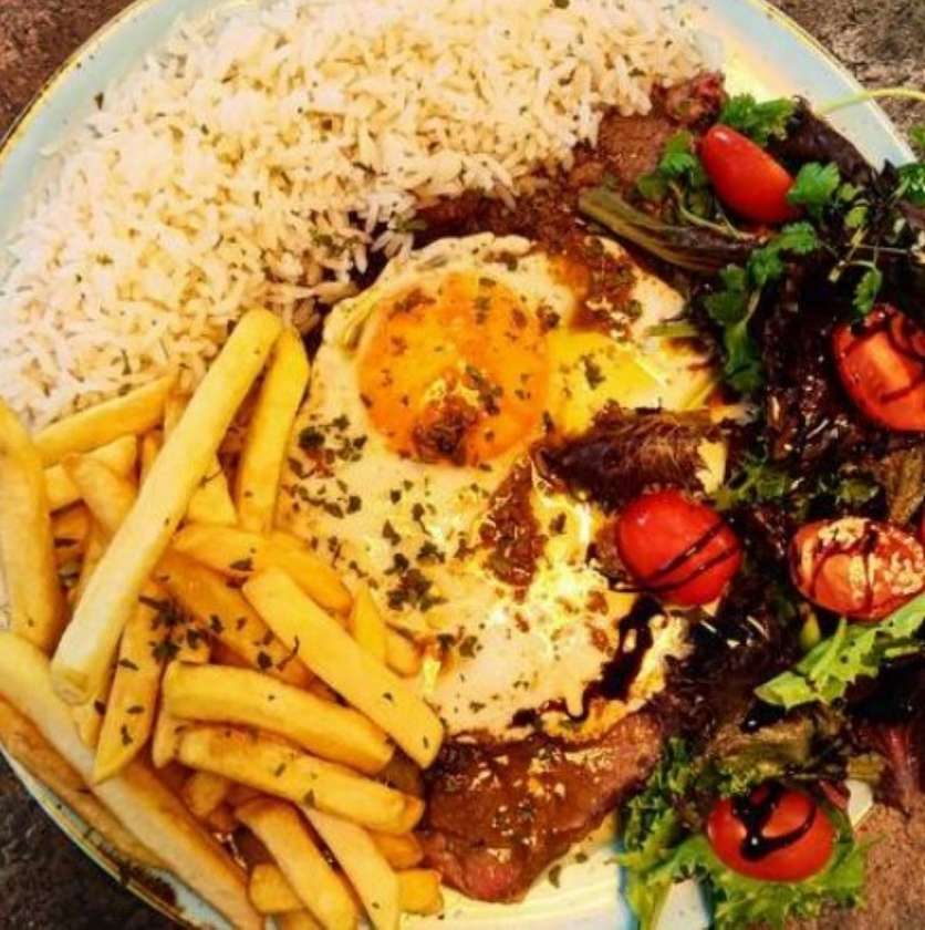 Steak with a fried egg and fries.