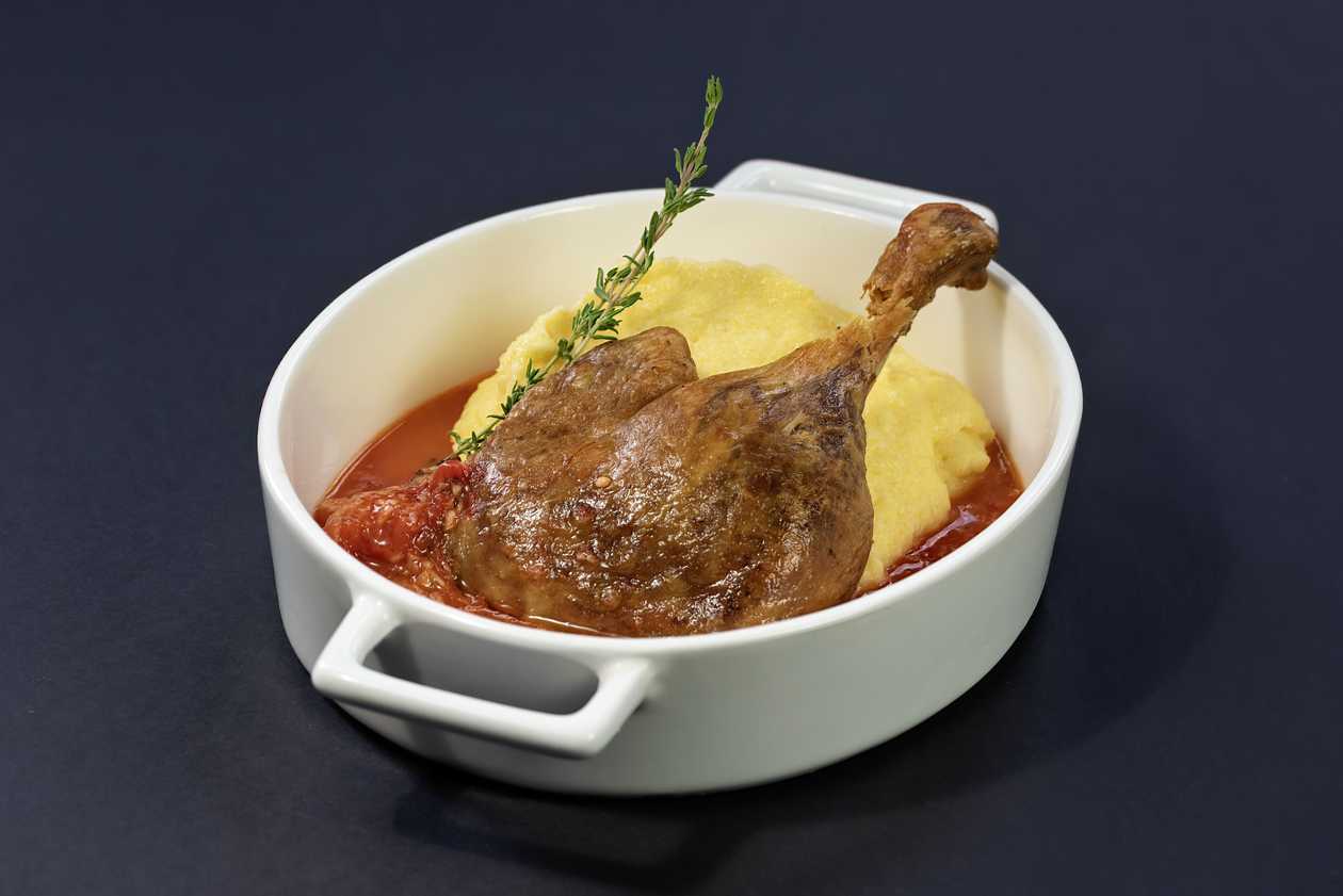 Confit Duck Thigh with Creamy Polenta and Roasted Tomato Garlic Sauce