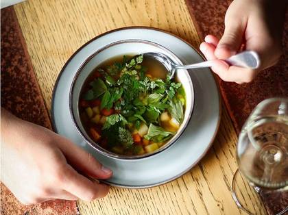 Poultry broth with roasted vegetables in butter