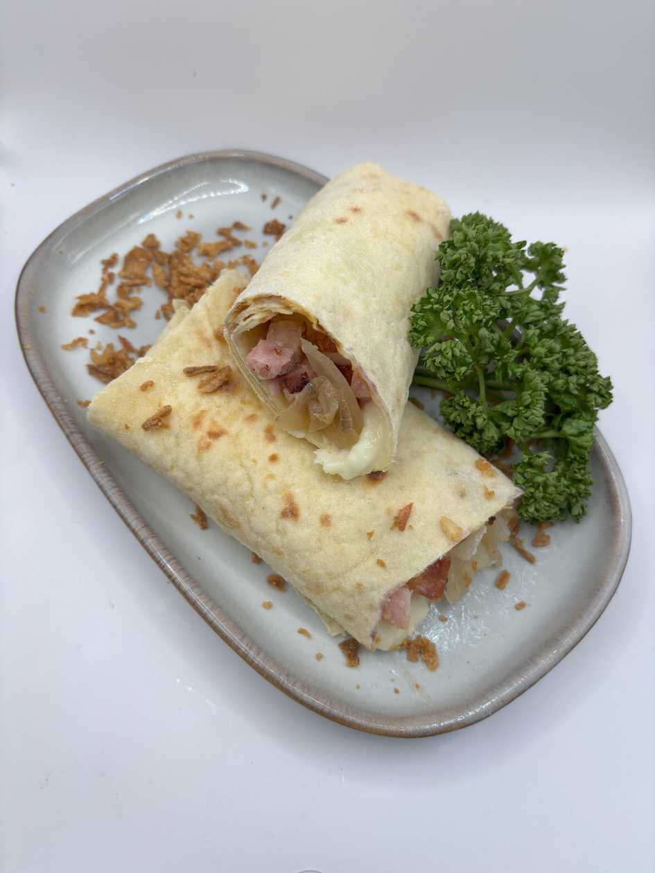 Potato pancake with brynza, bacon and onion