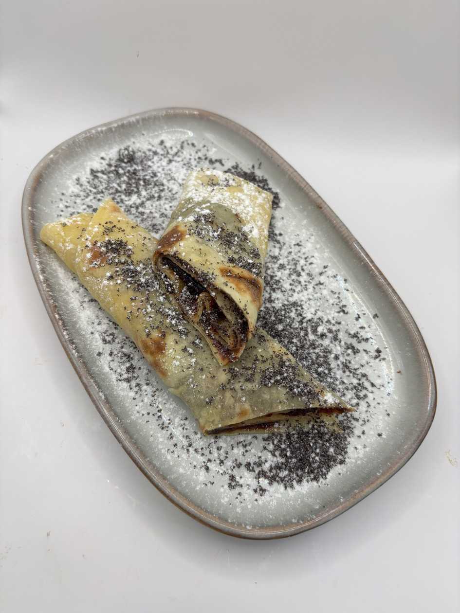 Potato pancake with plum jam and poppy