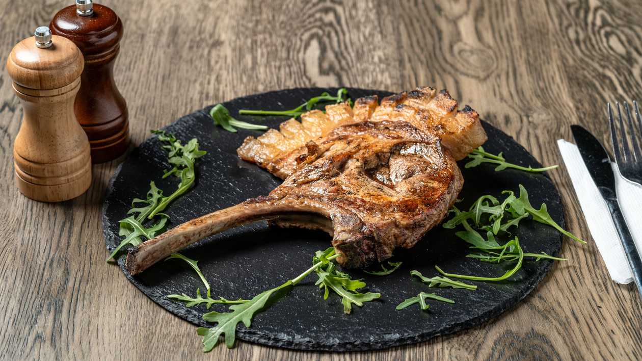 Pork Tomahawk with Baked Potatoes