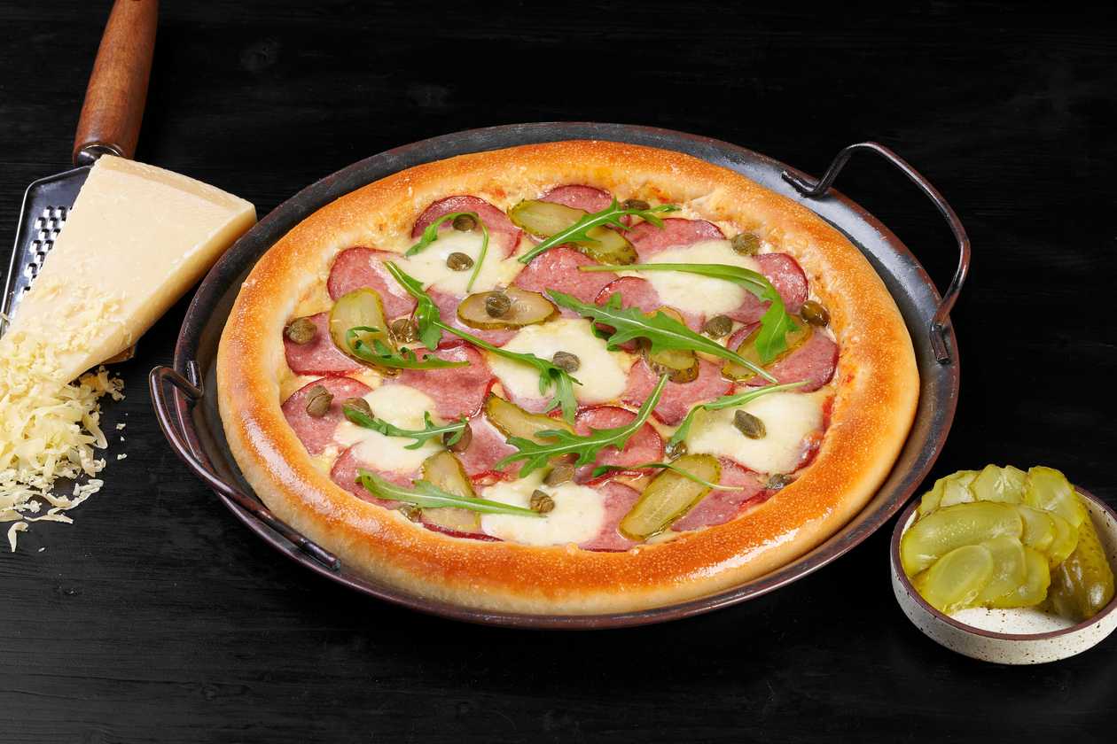 Salami thin-crust pizza