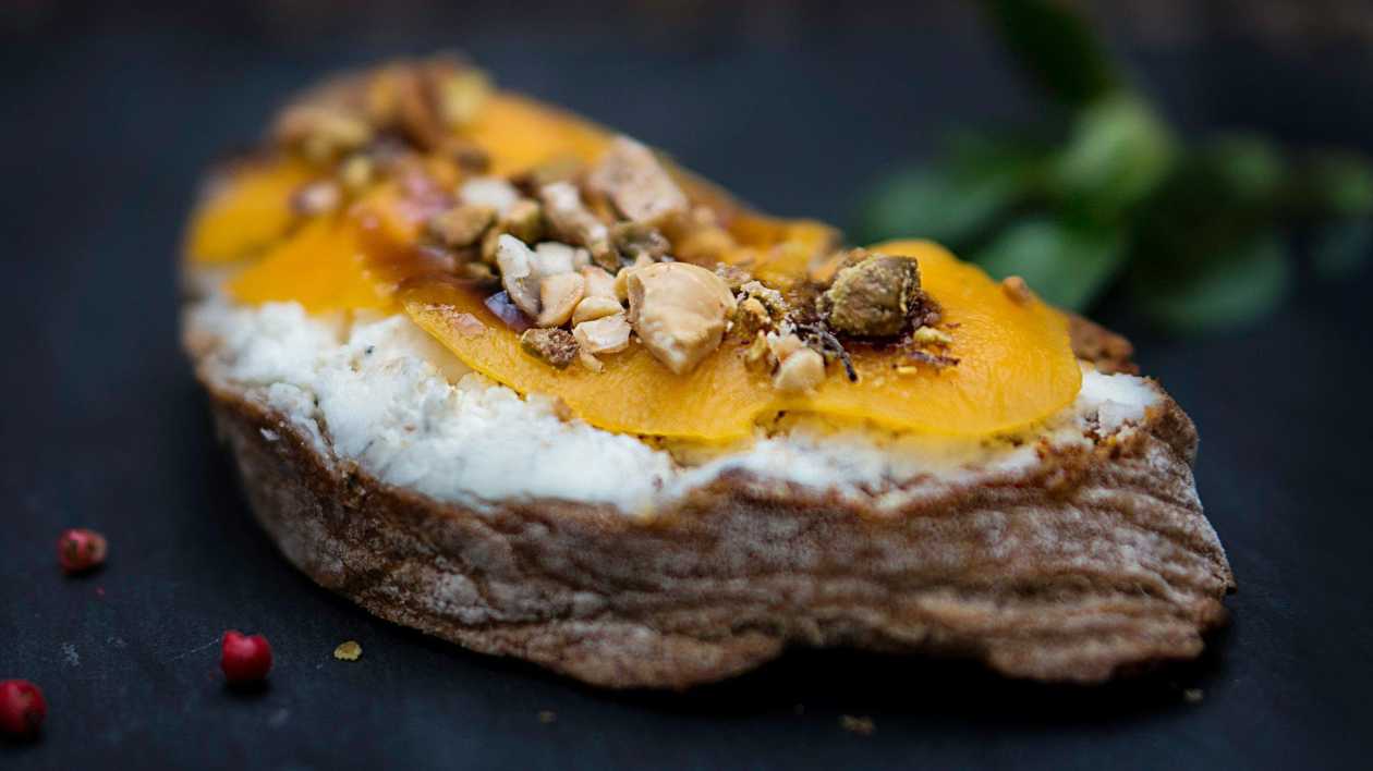 Bruschetta with goat cheese, mango, and hazelnuts