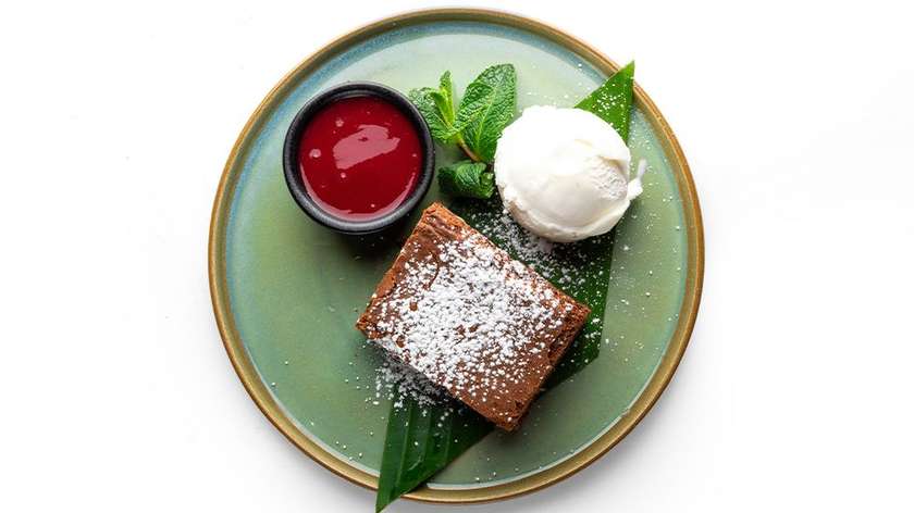 Brownie with ice cream and raspberry sauce