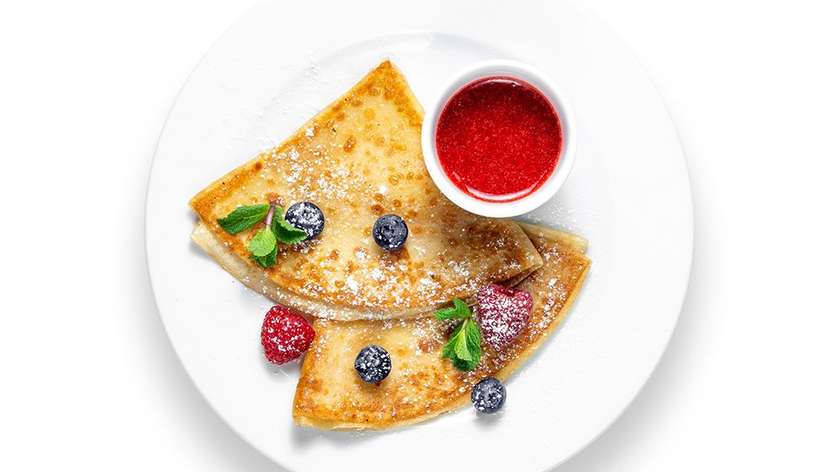 Crepes with straweberry jam and berries