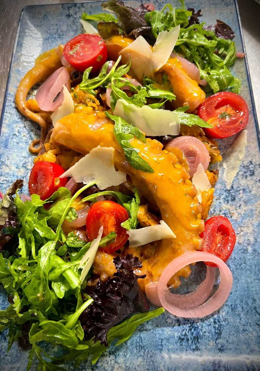 Warm Octopus Salad with Potato Wedges, Butter, and Herbs