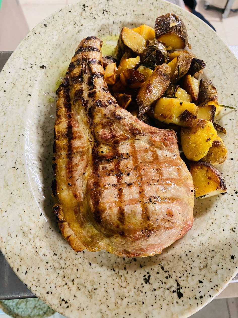 Pork Tomahawk with Crushed Potatoes and Garlic