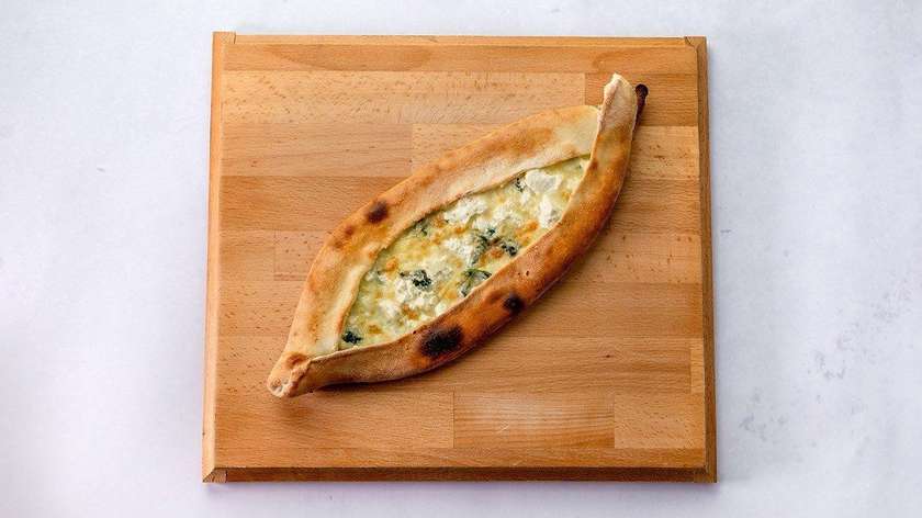 Pide with spinach, traditional Turkish cheese