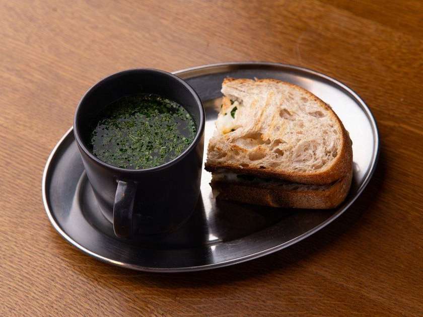 BOWL OF CHICKEN BROTH WITH A SANDWICH