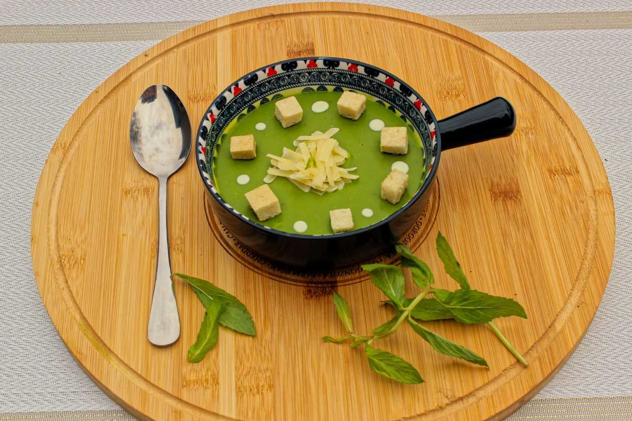 green pea cream soup with parmesan cheese fresh mint cream and garlic toasts