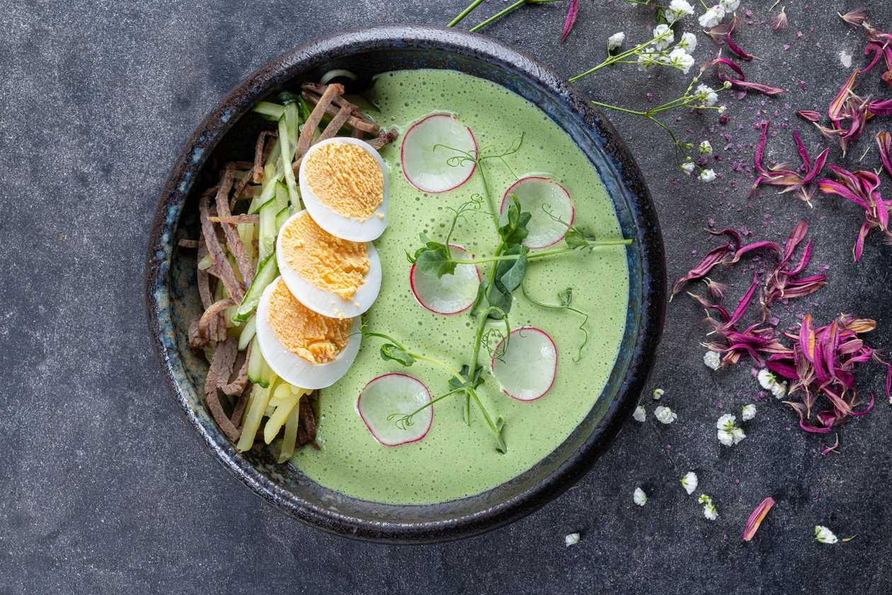 Okroshka with kefir, crunchy vegetables, and fresh herbs