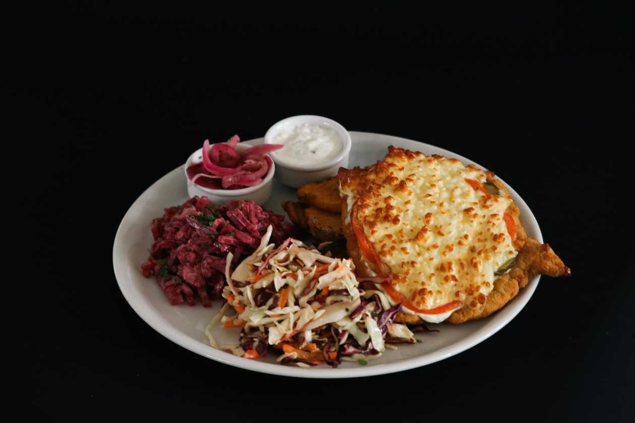 Pork chop Hedgehog's style with boiled-fried potatoes, pickled onions, coleslaw and beet salad
