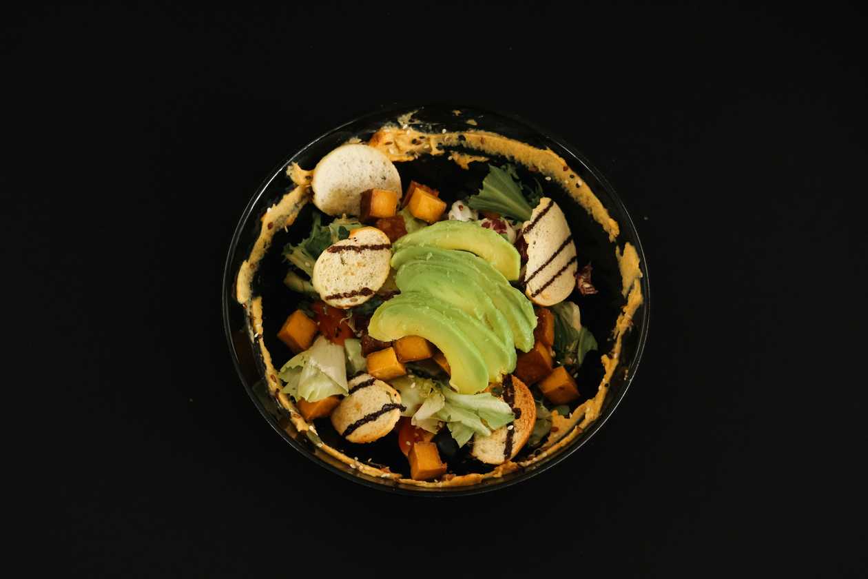 Tofu salad with avocado, sun-dried tomatoes and seeds