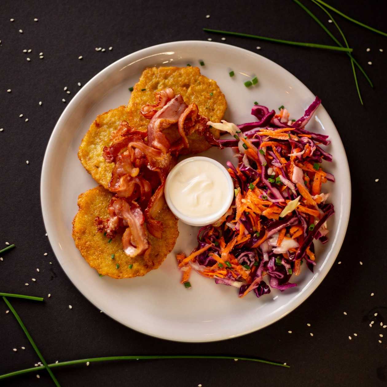 Potato pancakes with bacon and sour cream