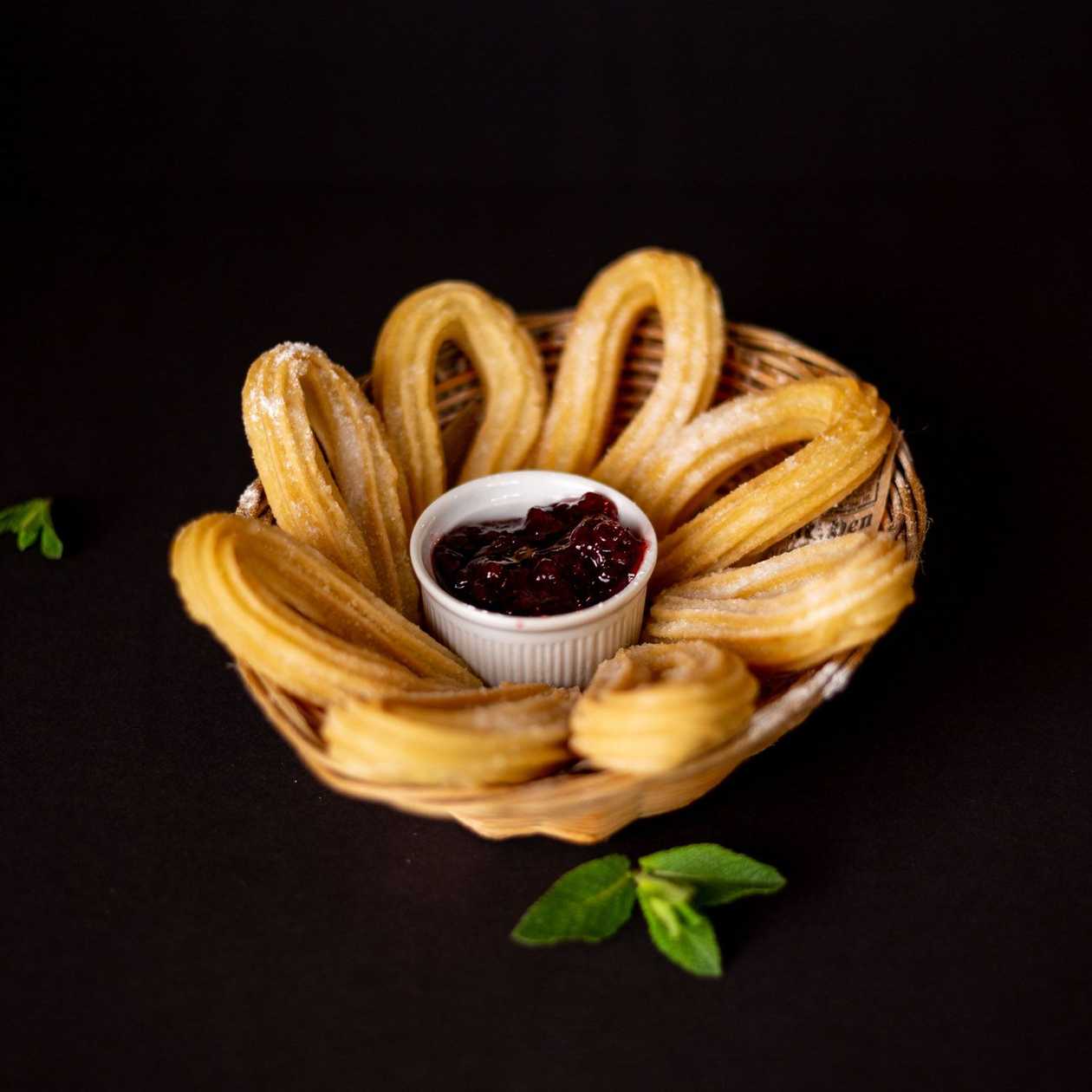 Churros with powdered sugar and lingonberry jam