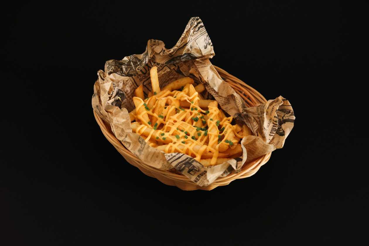 "Dirty fries" with crispy onions and Cheddar cheese sauce