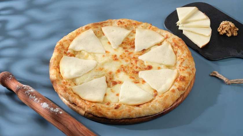 Khachapuri with extra cheese on top for a crispy, golden crust