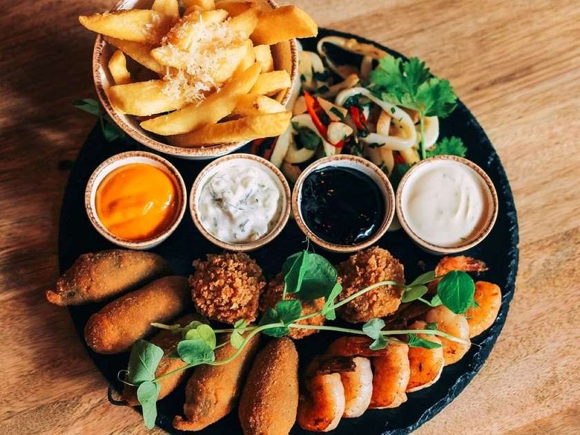 Fried Squid, Arancini, Shrimp, Jalapenos Stuffed with Cheddar Cheese, Fries with Parmesan and Truffle Oil, Tartar Sauce, and Black Aioli
