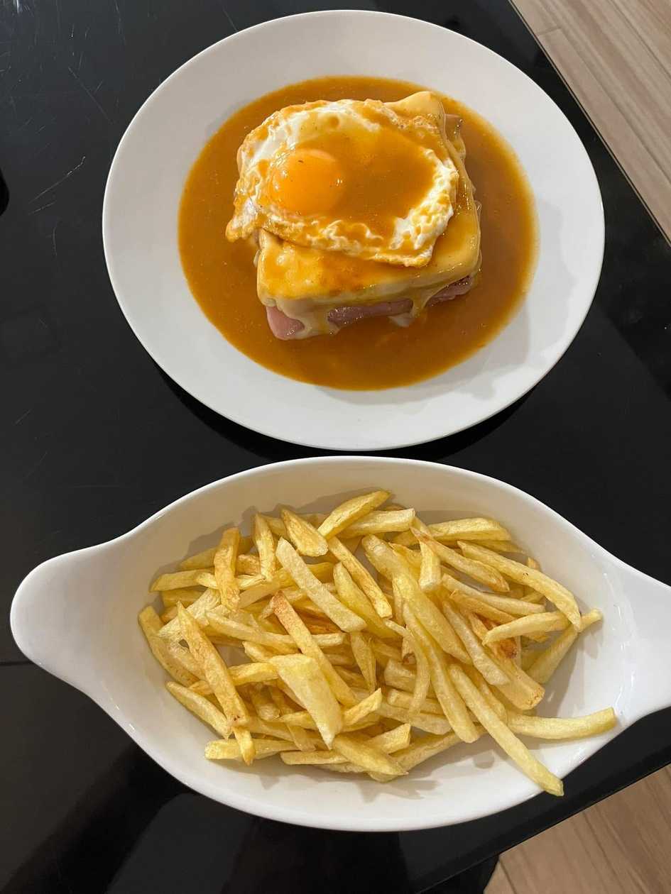Special Francesinha with fries and a fried egg