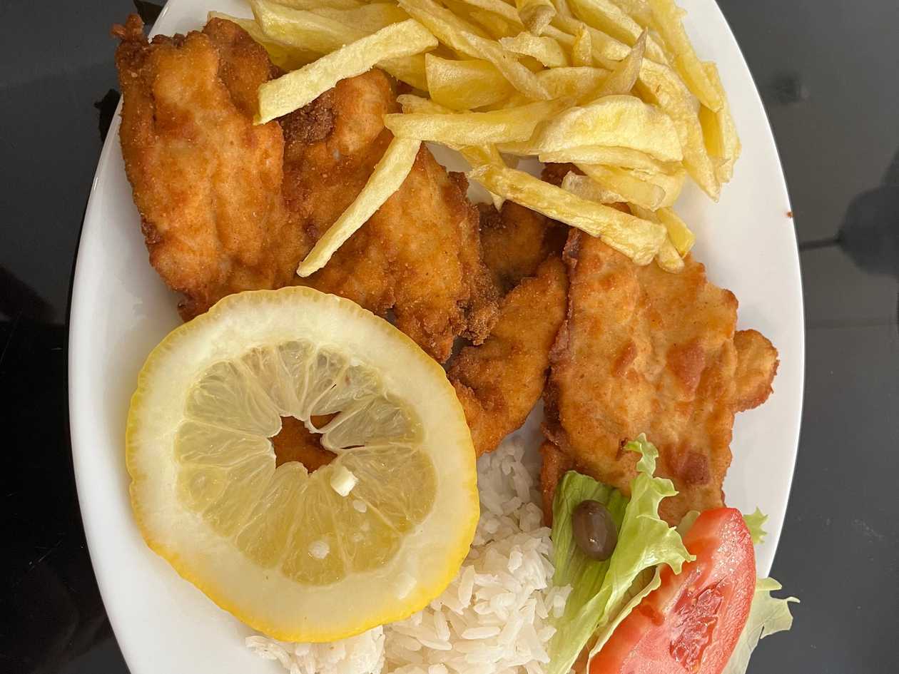 Breaded chicken steak with rice and fries