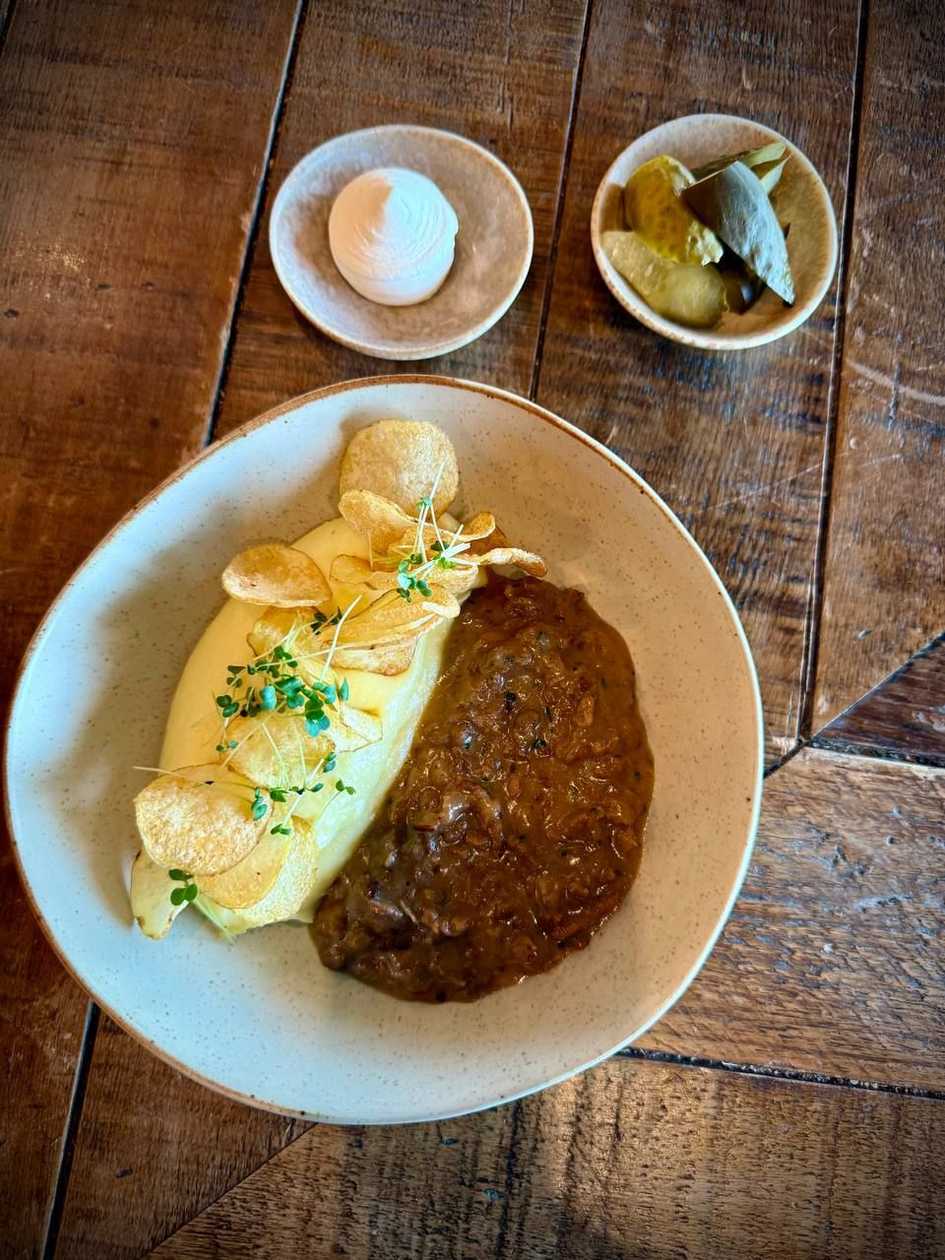 Beef Stroganoff with mashed potatoes and pickled cucumbers