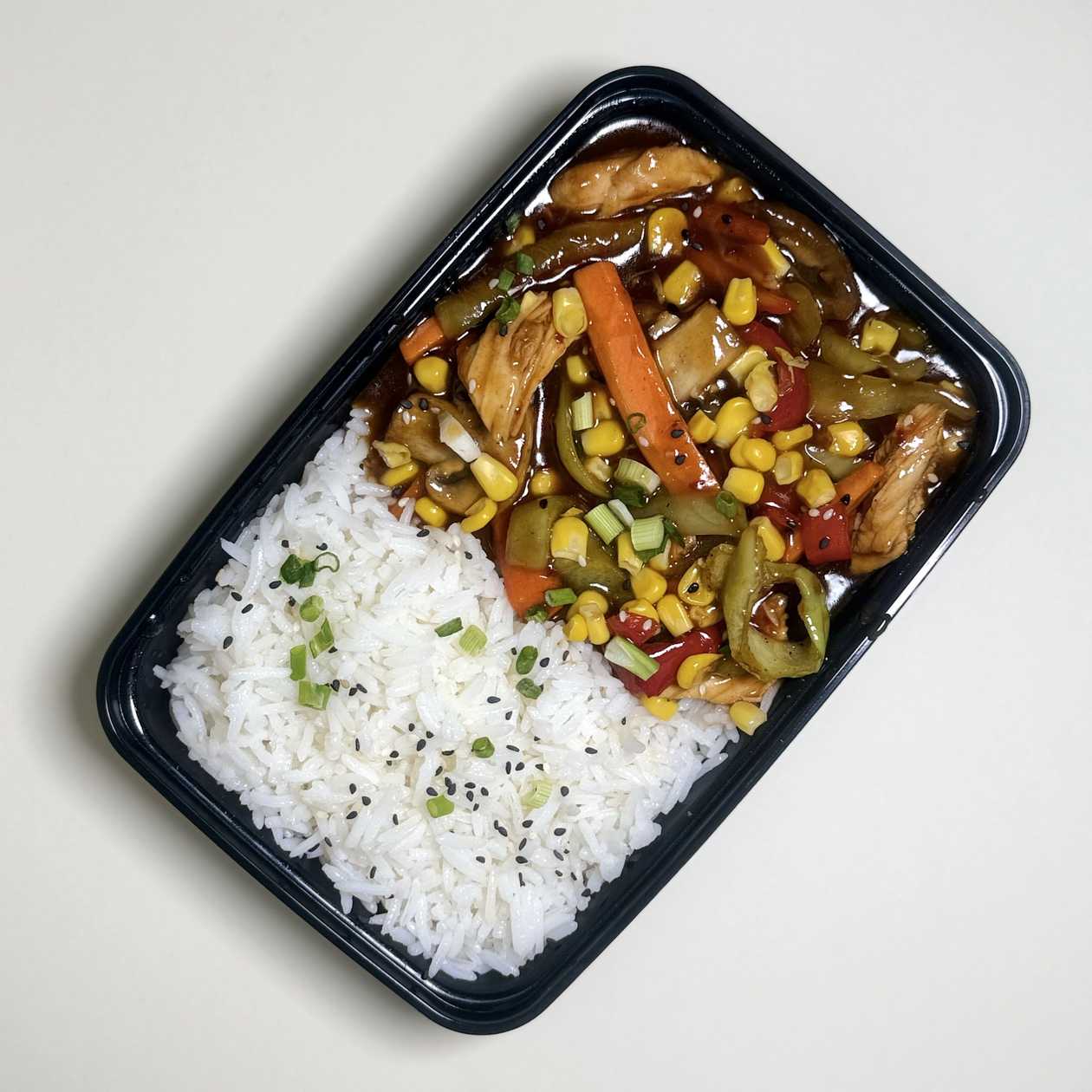 Chicken with sweet and spicy sauce and rice garnish