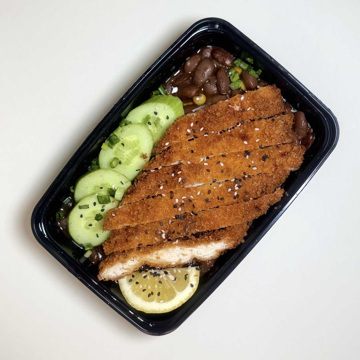 Schnitzel, Mexican bean garnish, cucumber and bread