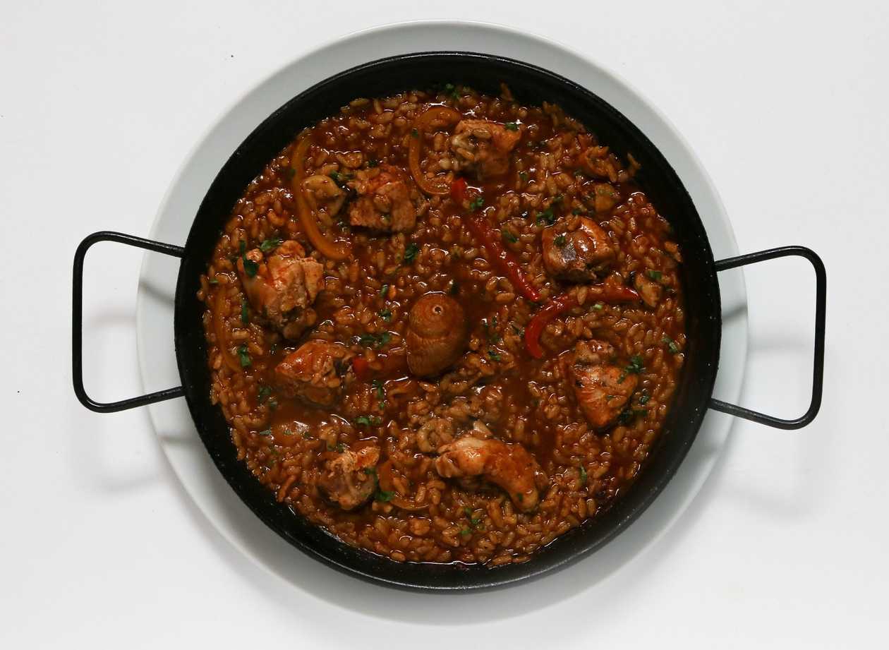 Paella Valenciana with rabbit and chicken, snails and vegetables
