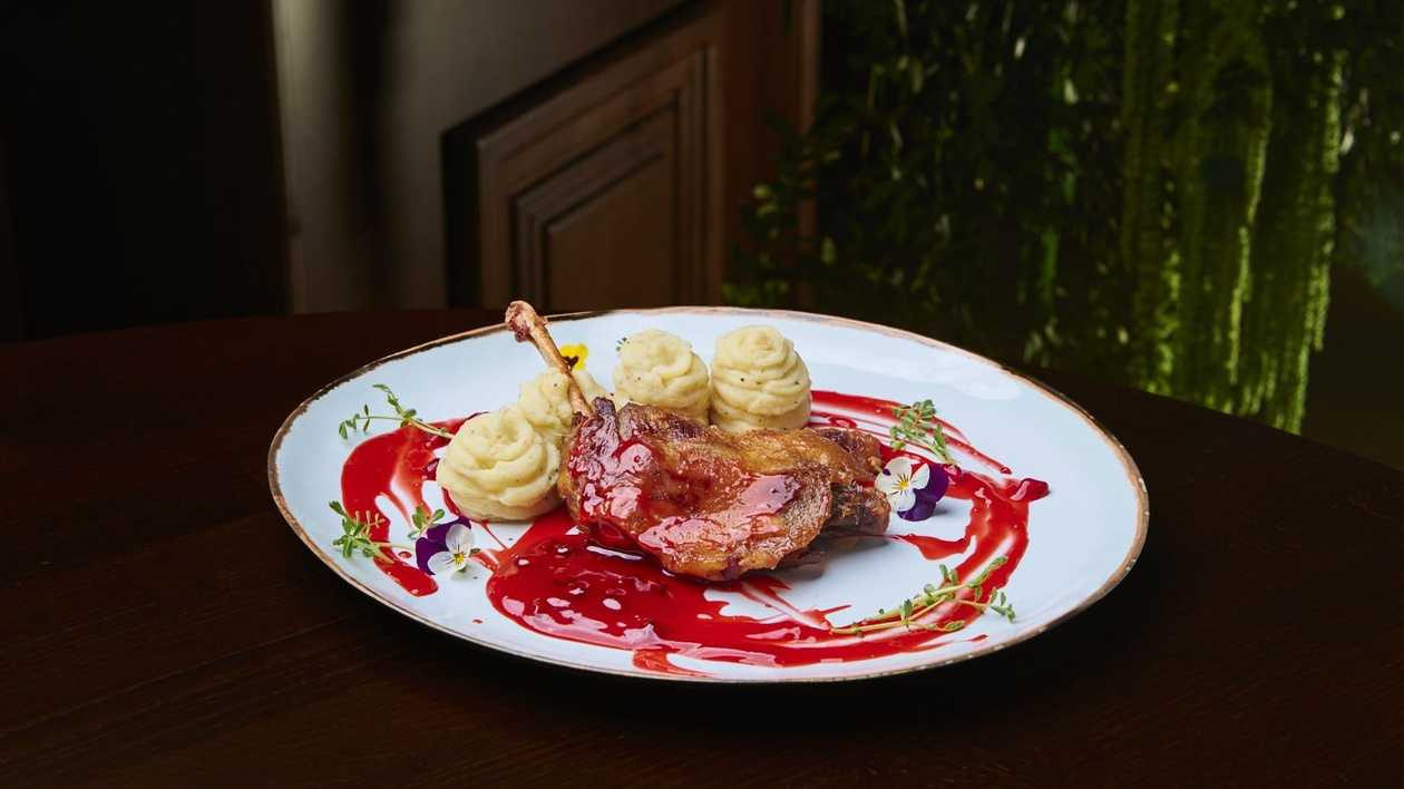 Duck Confit Legs, Slow Baked, Served with Sautéed Cabbage and Hot Pepper