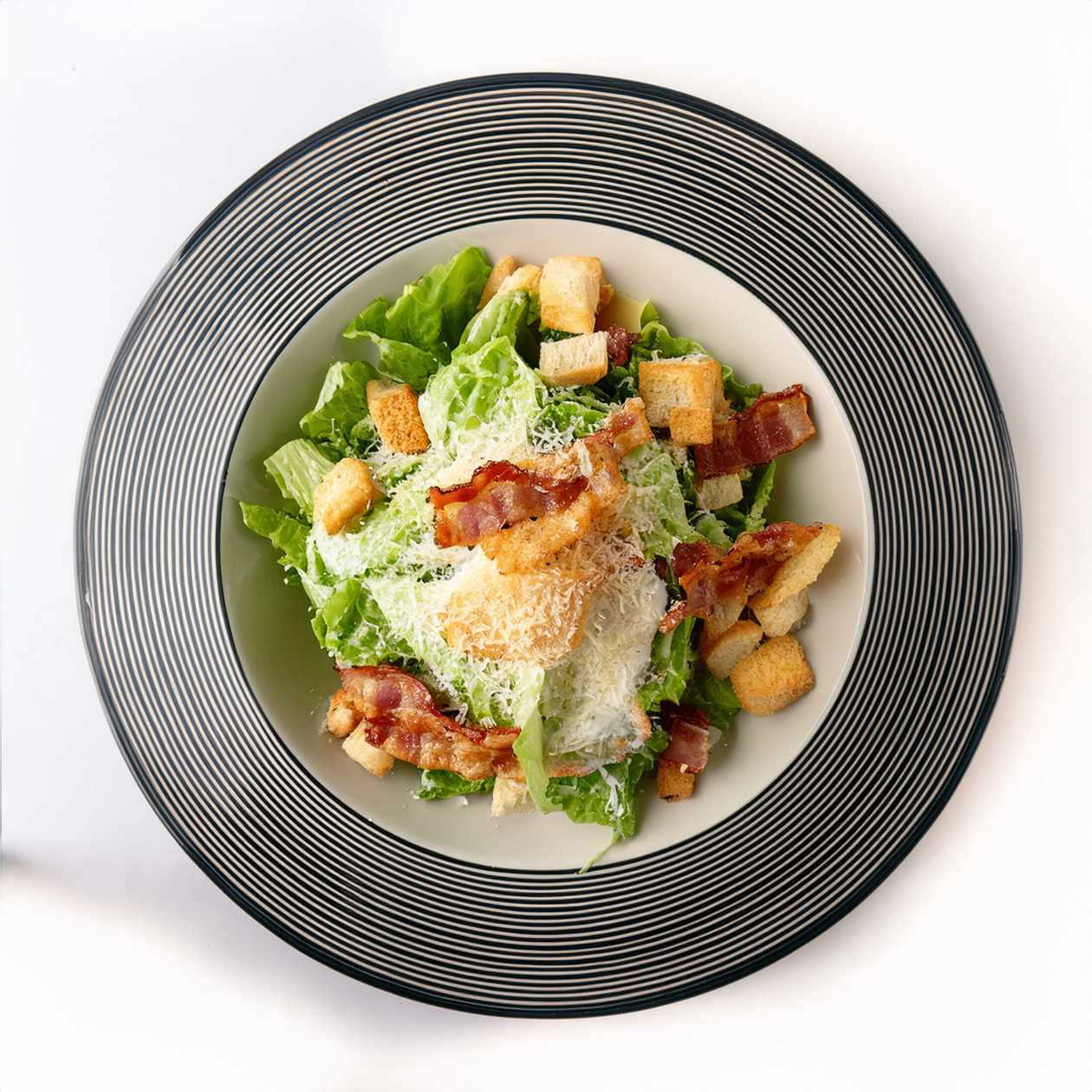 Prameň Salad with Crispy Chicken, Bacon Chips, Caesar Dressing, Parmesan, Croutons