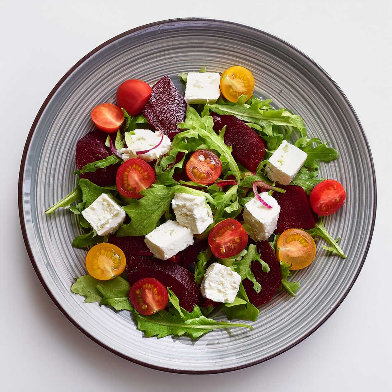 Fresh Salad with Goat Cheese, Cherry Tomatoes, Red Beetroot, and Homemade Dressing
