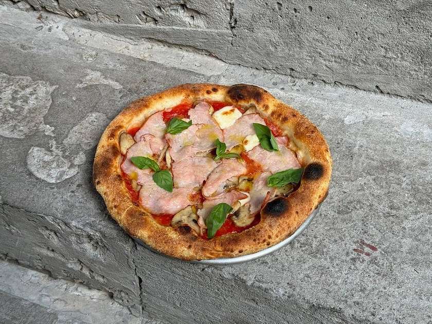 Pizza with chili champignon mushrooms and ham