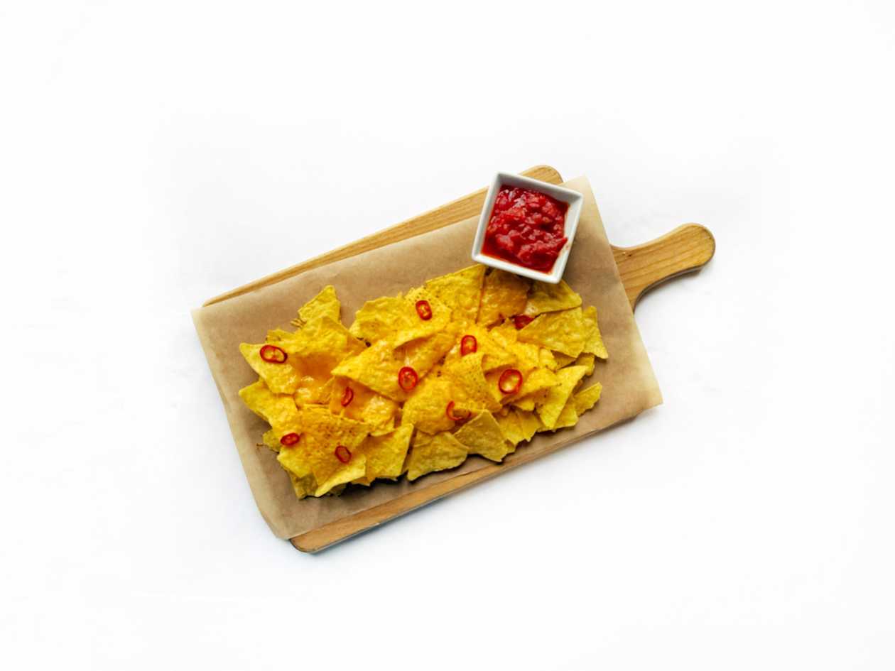 Corn nachos baked with cheddar, chilli and tomato salsa