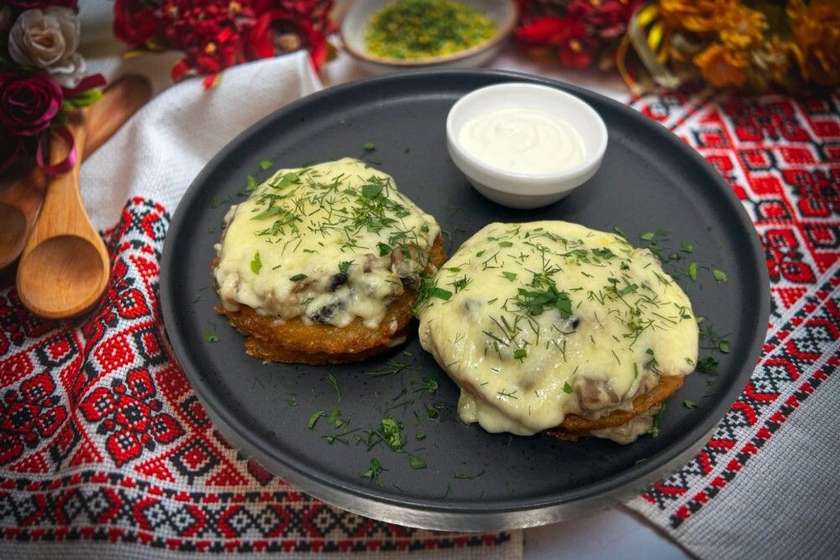 Potato pancakes with mushrooms, cheese and sour cream