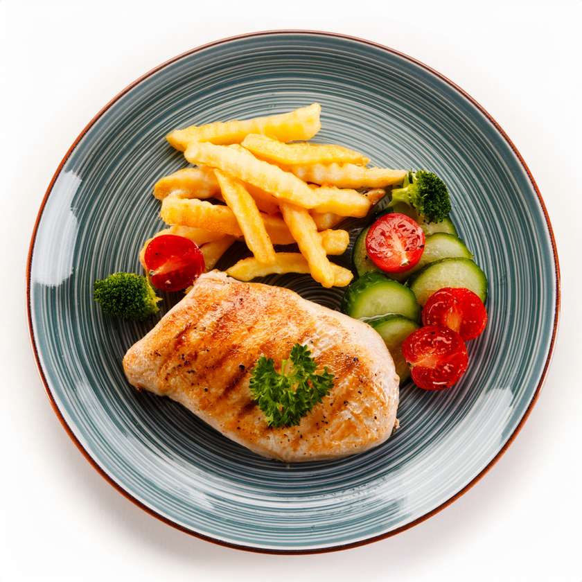 Chicken breast in butter with vegetables, fries
