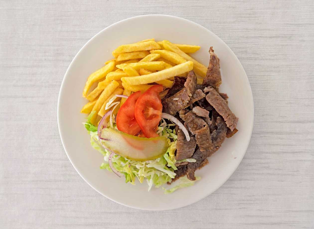 Veal kebap on a plate with side dish